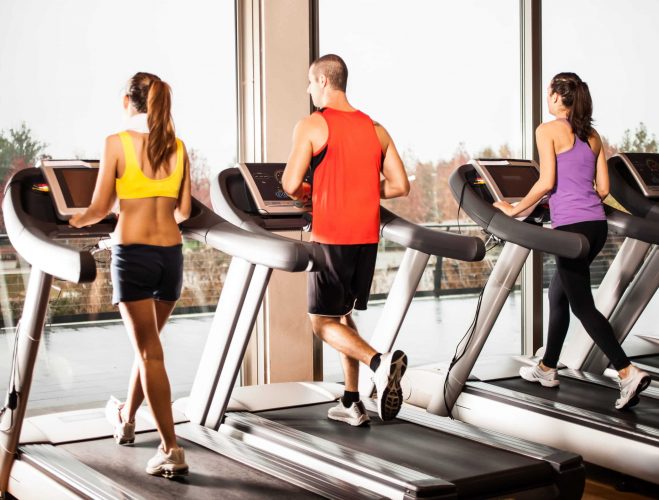 Gropu of people running on treadmills